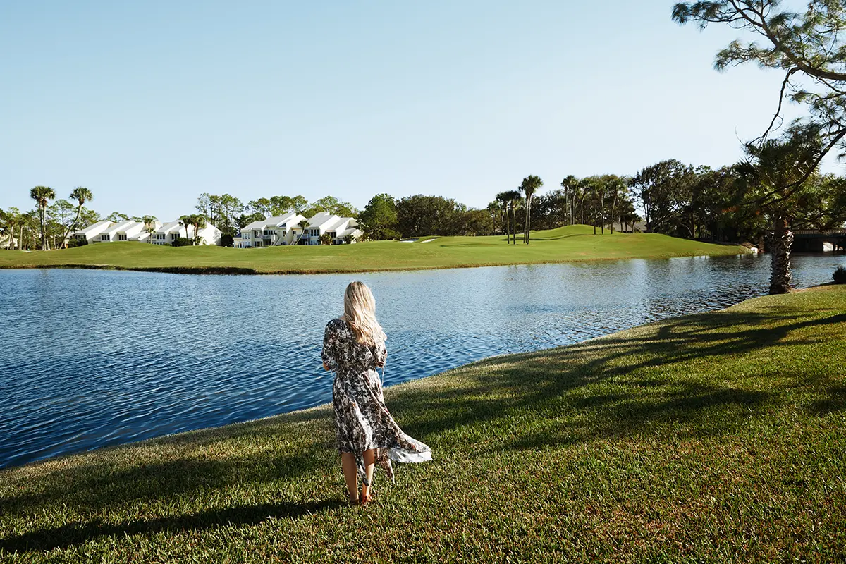 Photo of a woman standing by a lake in Florida.