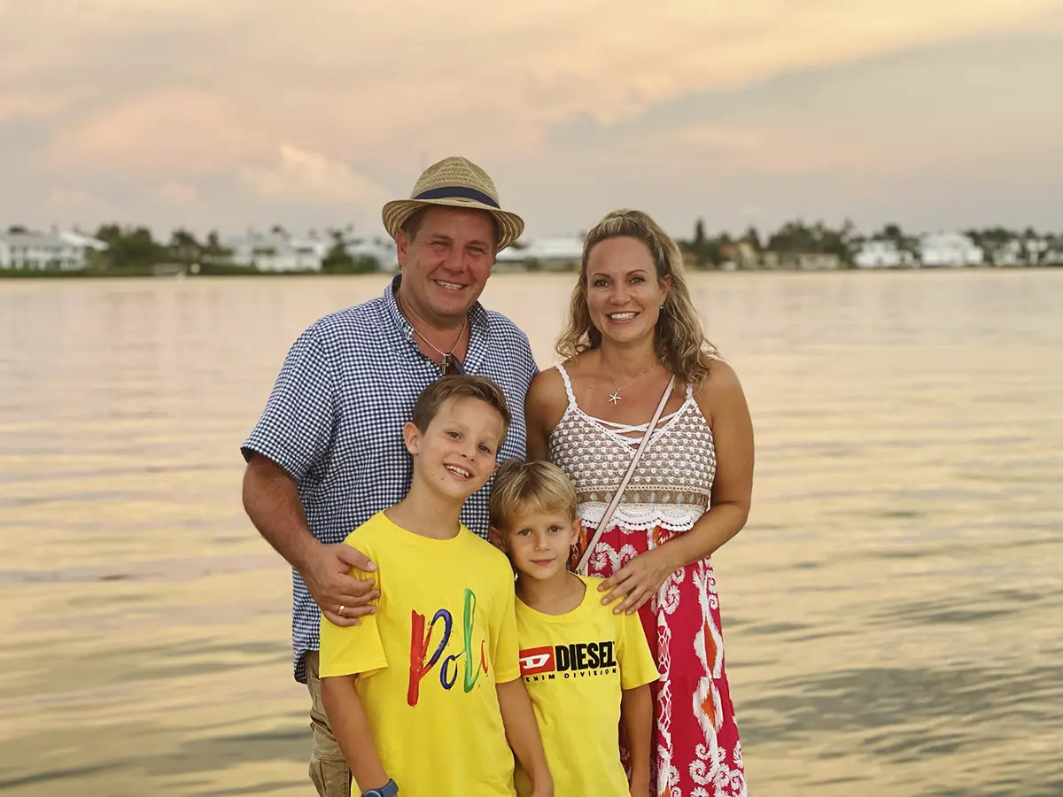 Photo of Marco and Verena Schmatloch with their family in Florida at sunset.