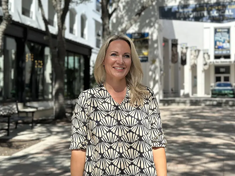 Photo of Verena Schmatloch, co-owner of VMS Florida Realty, standing in downtown Naples.