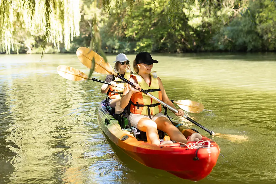A mother and daughter kayaking down a Florida river.