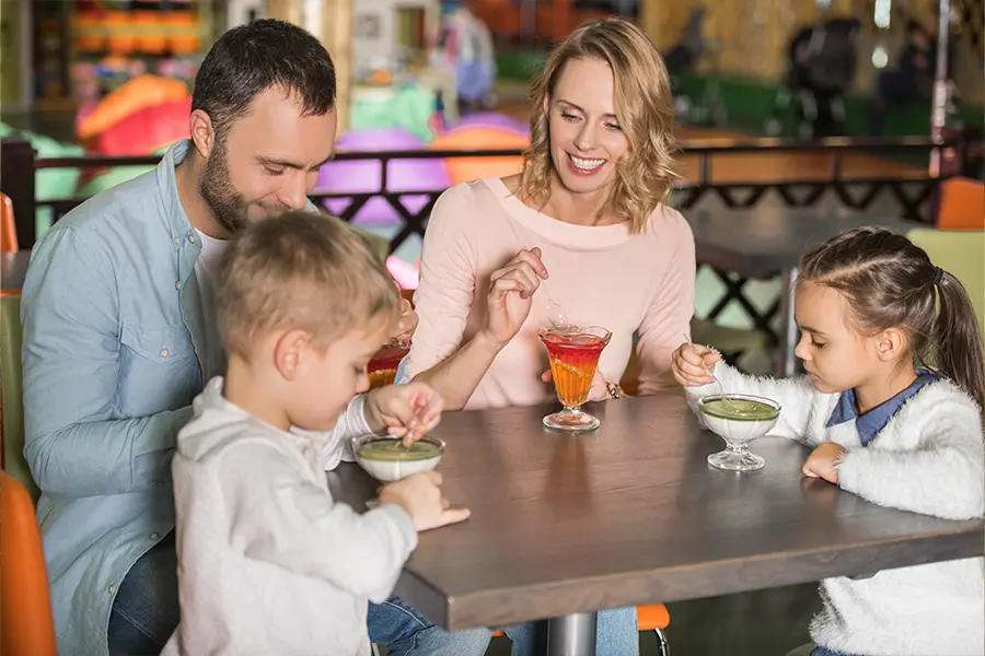 A young family at a cafe, enjoying specialty drinks.